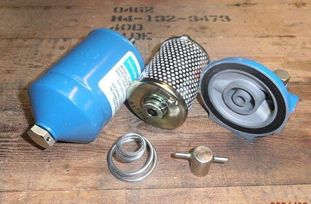 Compact Filter Element Seal Breakdown Compact Vokes filter dismantled showing bowl, element, cover seal and spring